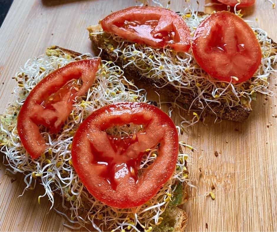 chickpea-hummus-sprouts-tomatoe-sandwich-cutting-board