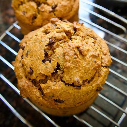 two banana pumpkin muffins on a cooling rack