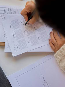 women writing in a calendar planner