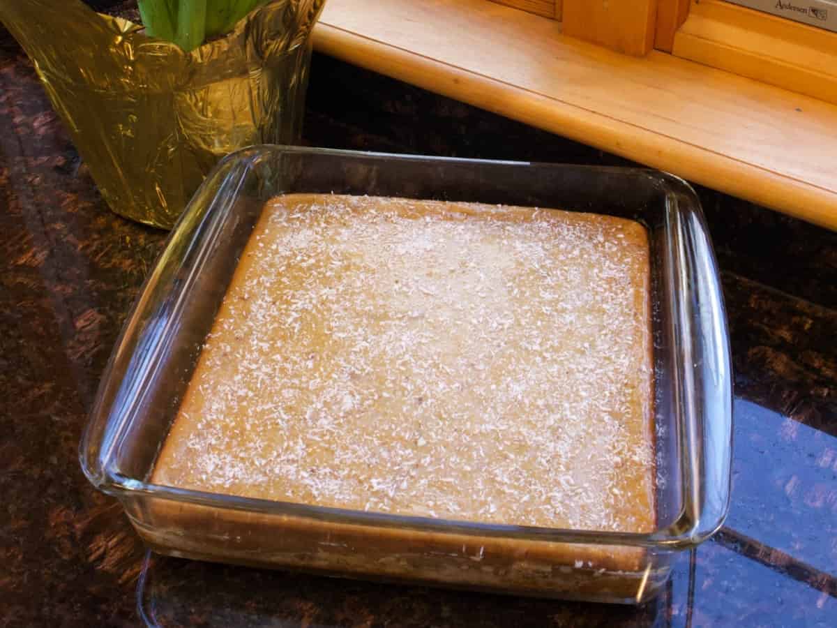 lemon zucchini cake in square pan on counter