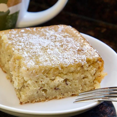 piece of lemon zucchini cake on plate with fork