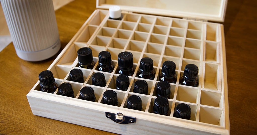 summer essential oil blend bottles in storage container