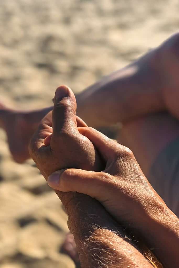 two-holding-hands-on-beach