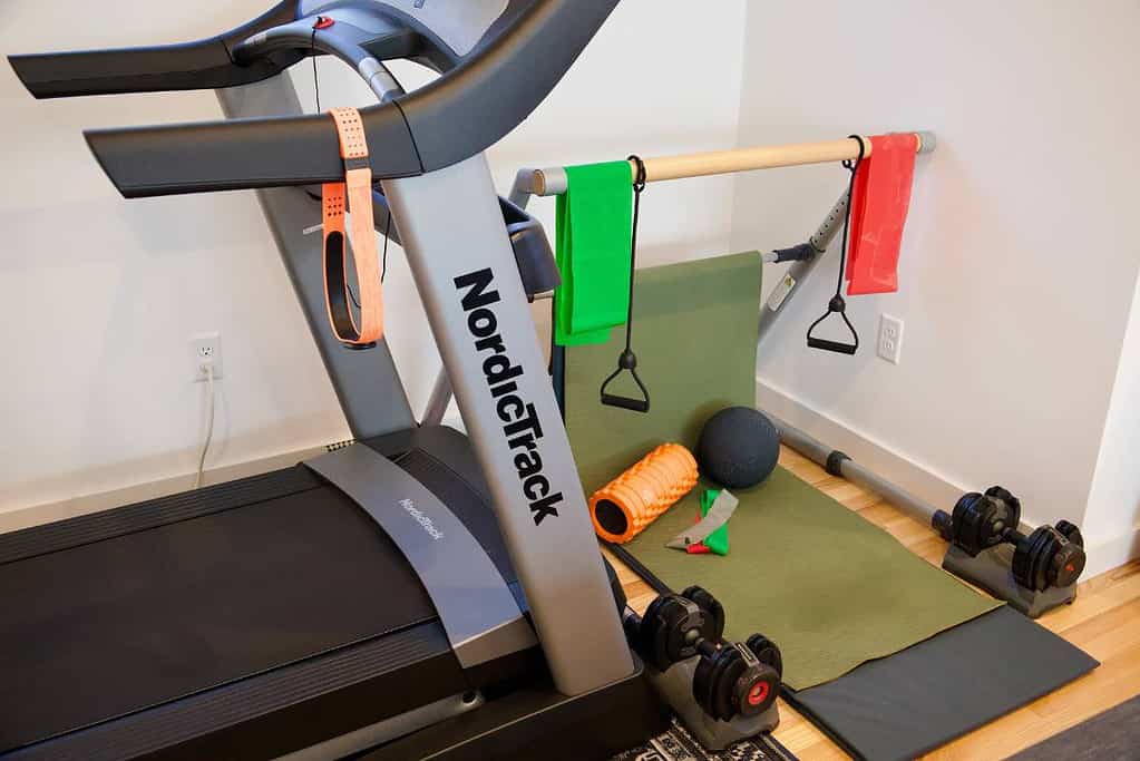 minimalist-home-gym-treadmill-bands-yoga-mat-weights-foam-roller