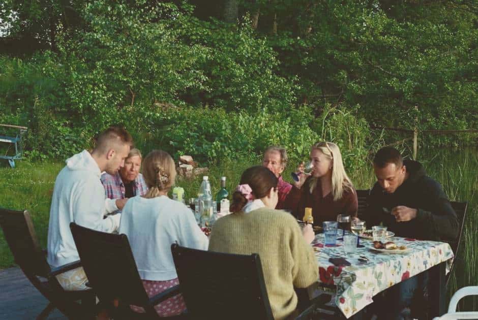 friends-eating-dinner-around-a-table-in-the-garden
