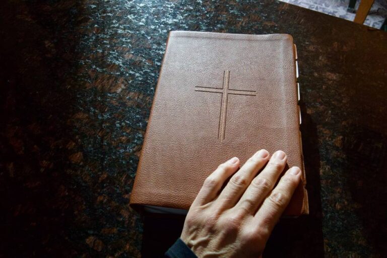 hand-on-closed-bible