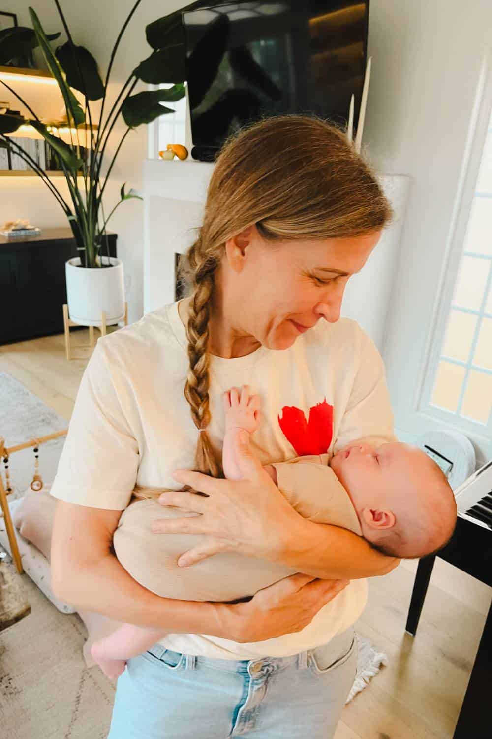 dawn-cradling-a-baby-in-her-arms-looking-down-smiling