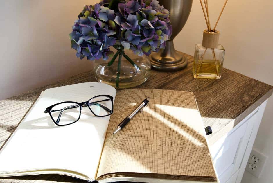 blank-journal-opened-glasses-pen-vase-of-hydrangeas
