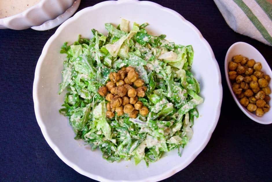 vegan-caesar-salad-in-large-white-bowl-roasted-chickpeas-on-the-side