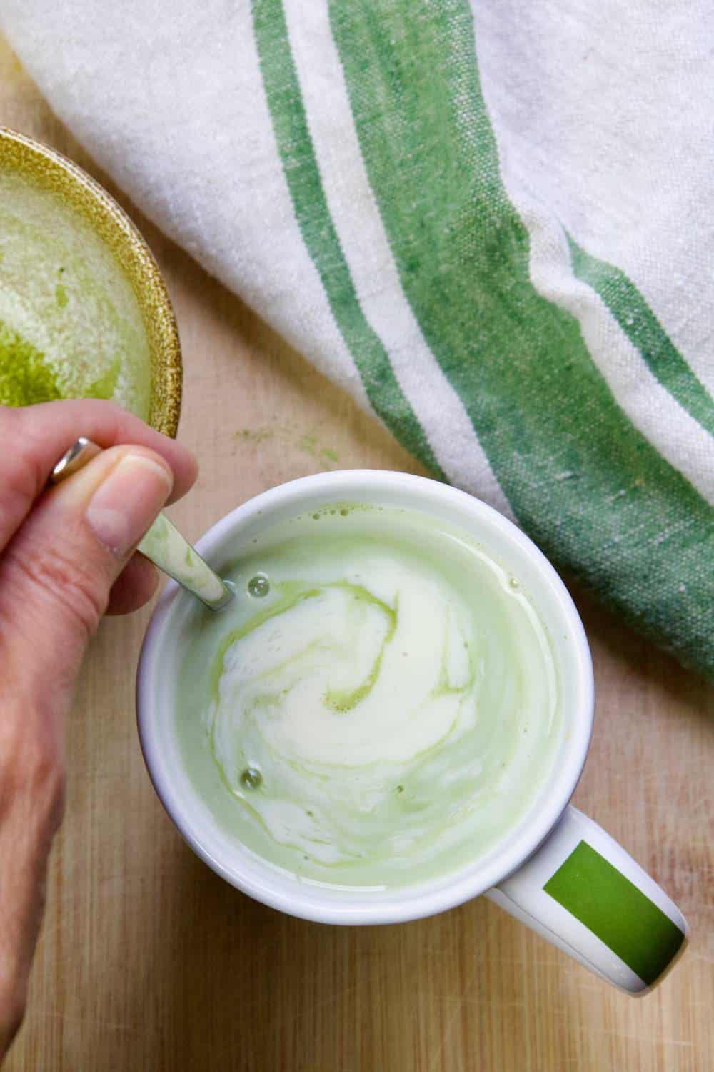 stirring matcha into cup with non-dairy milk