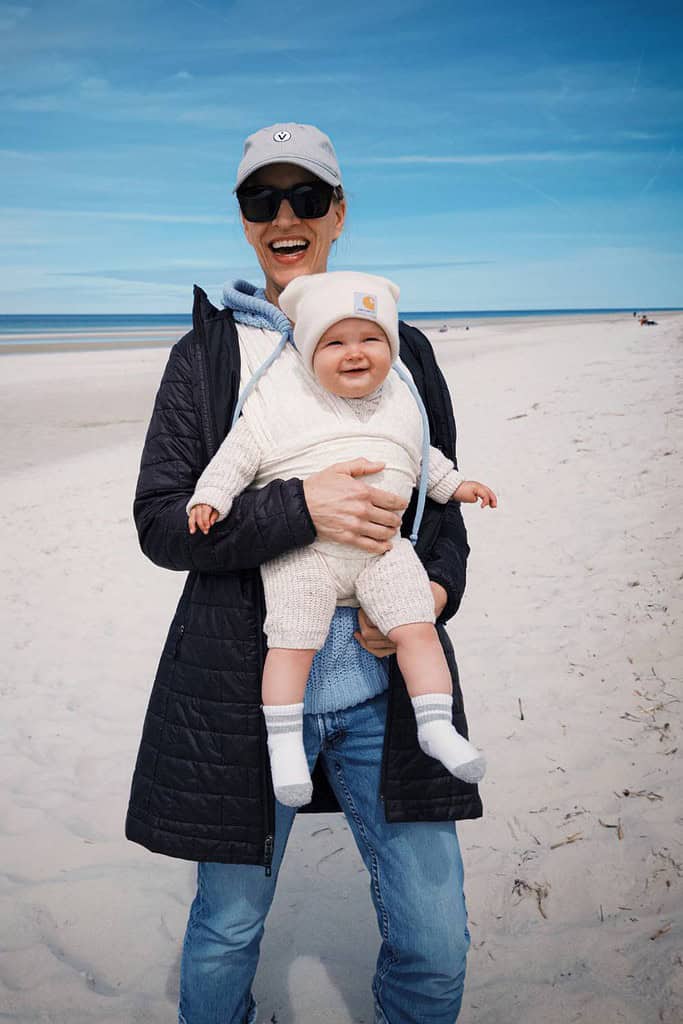 dawn carrying grandbaby on the beach laughing