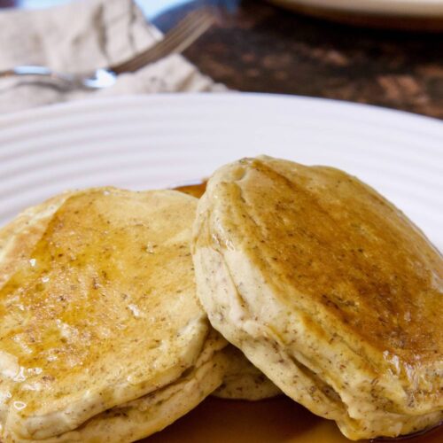 sourdough discard pancakes on a plate with maple syrup