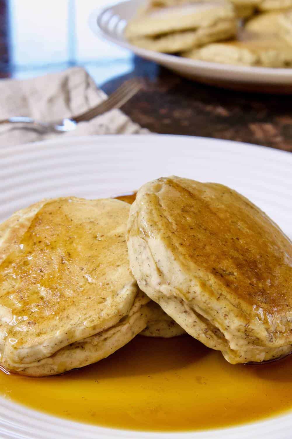 sourdough discard pancakes on a plate with maple syrup