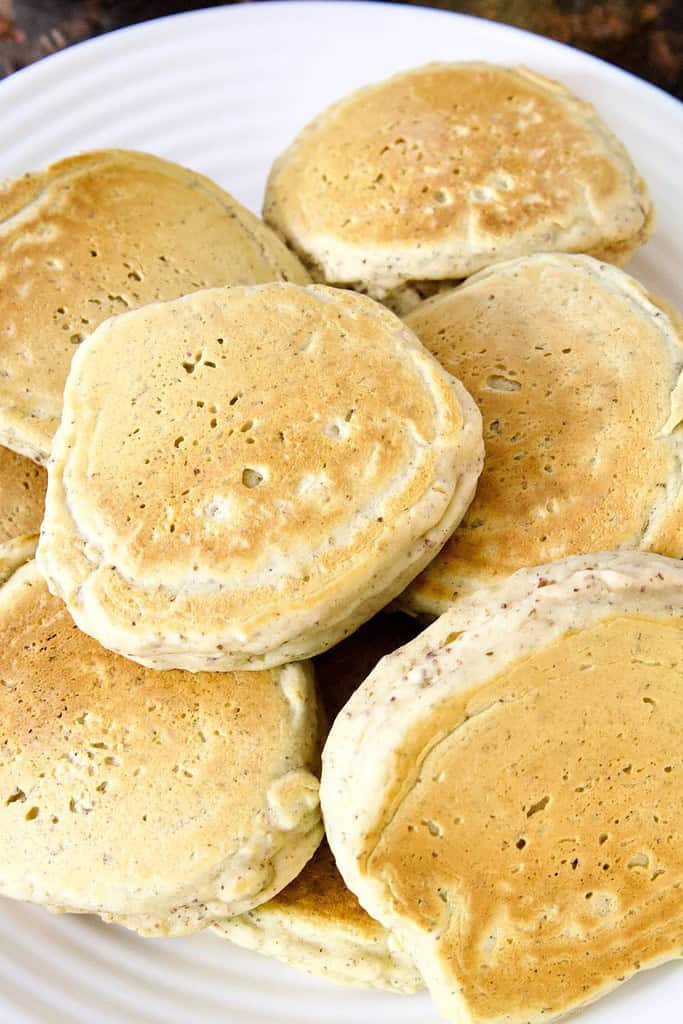 several small sourdough pancakes on a white plate