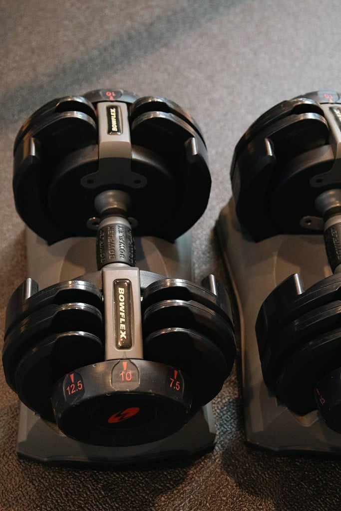 adjustable dumbbells in their stand