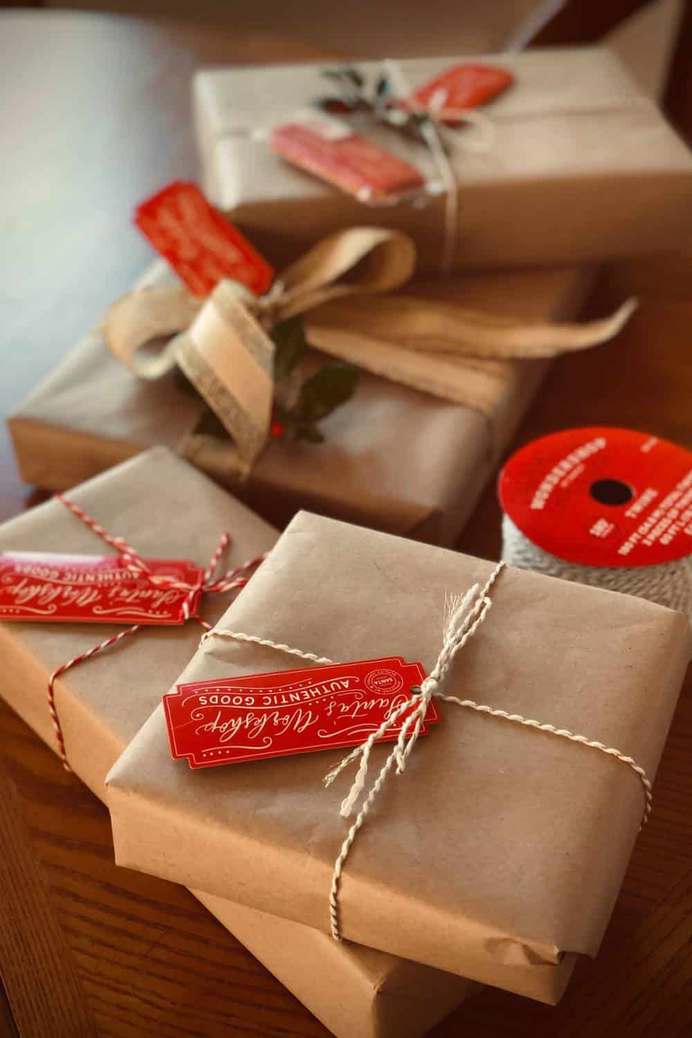 Caregiver gifts wrapped in brown paper and string with red gift tags attached.