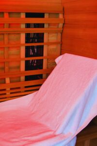 inside of a sauna with a towel and bench