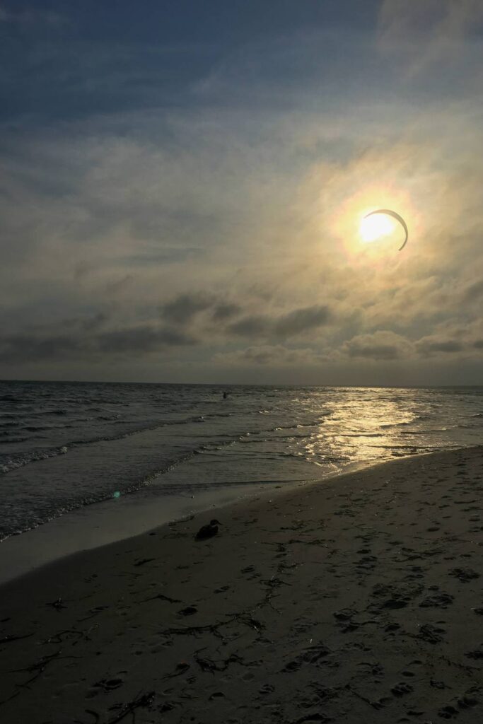 ocean beach on a cloudy evening with sun setting