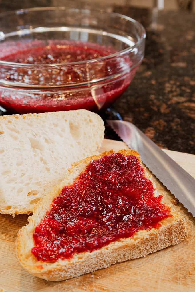 cranberry raspberry sauce spread on sourdough bread