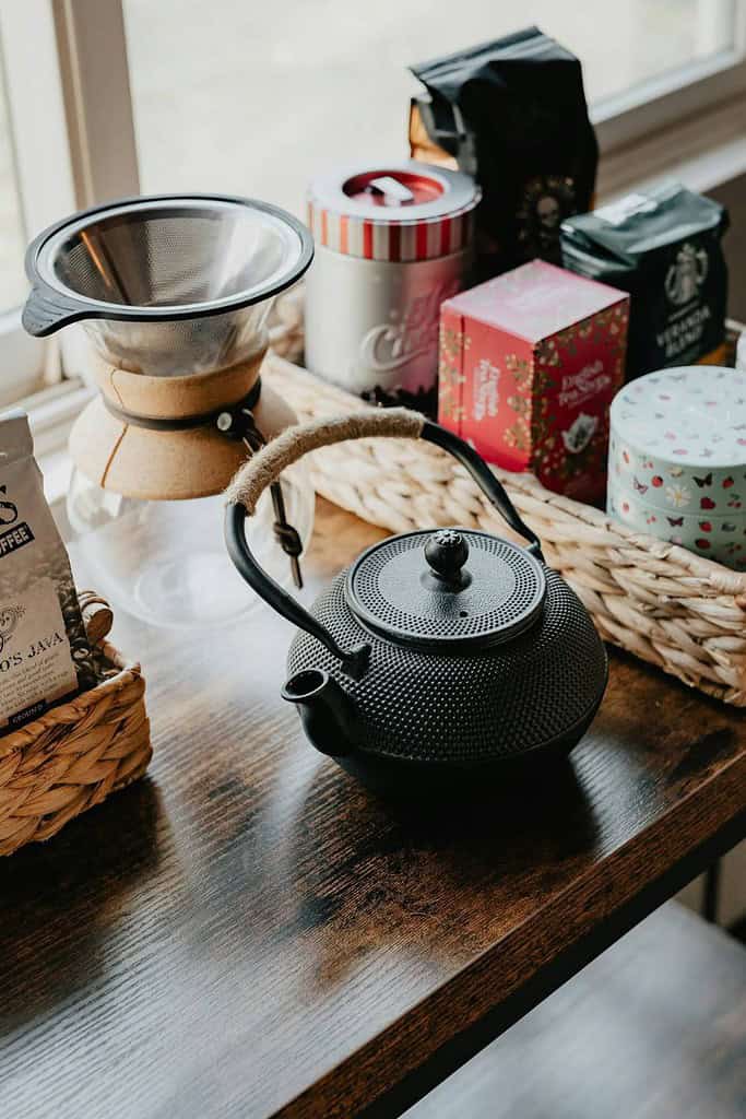 basket of coffee tins and tea with small teapot