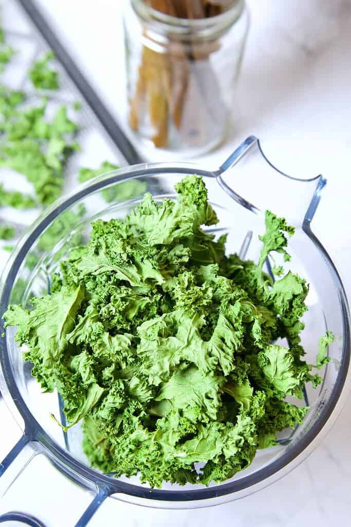 dehydrated kale in a blender ready to be made into a diy green powder