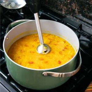 an immersion blender in the soup pot ready to cream the lentil soup