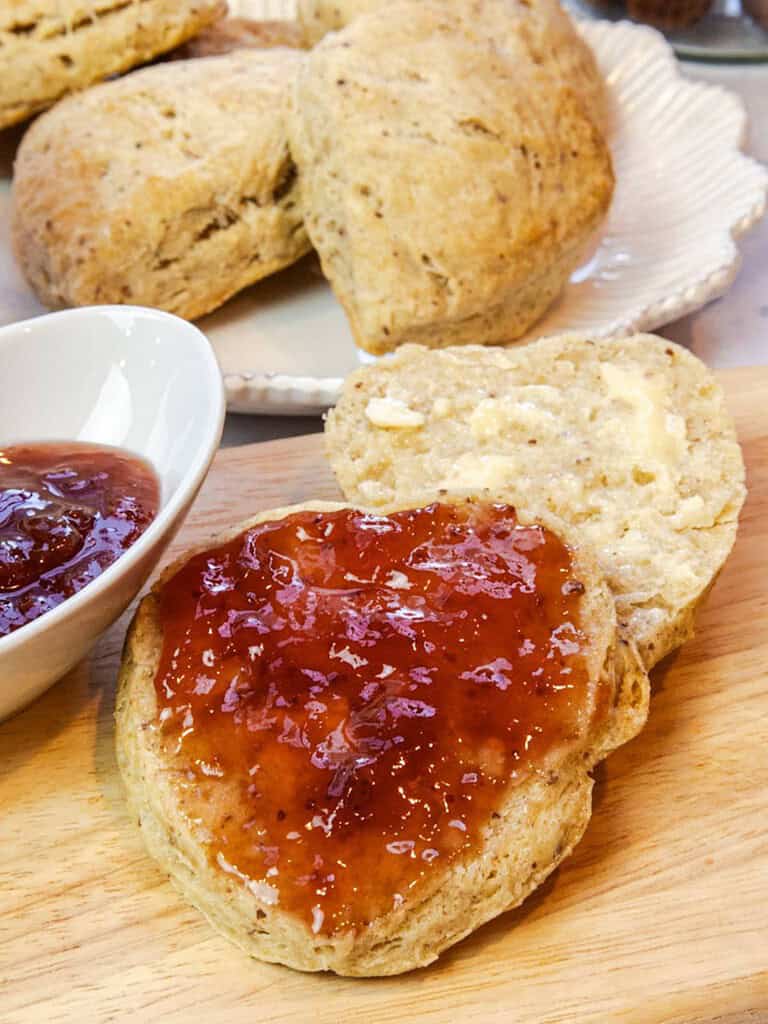 sliced scone with butter and jam