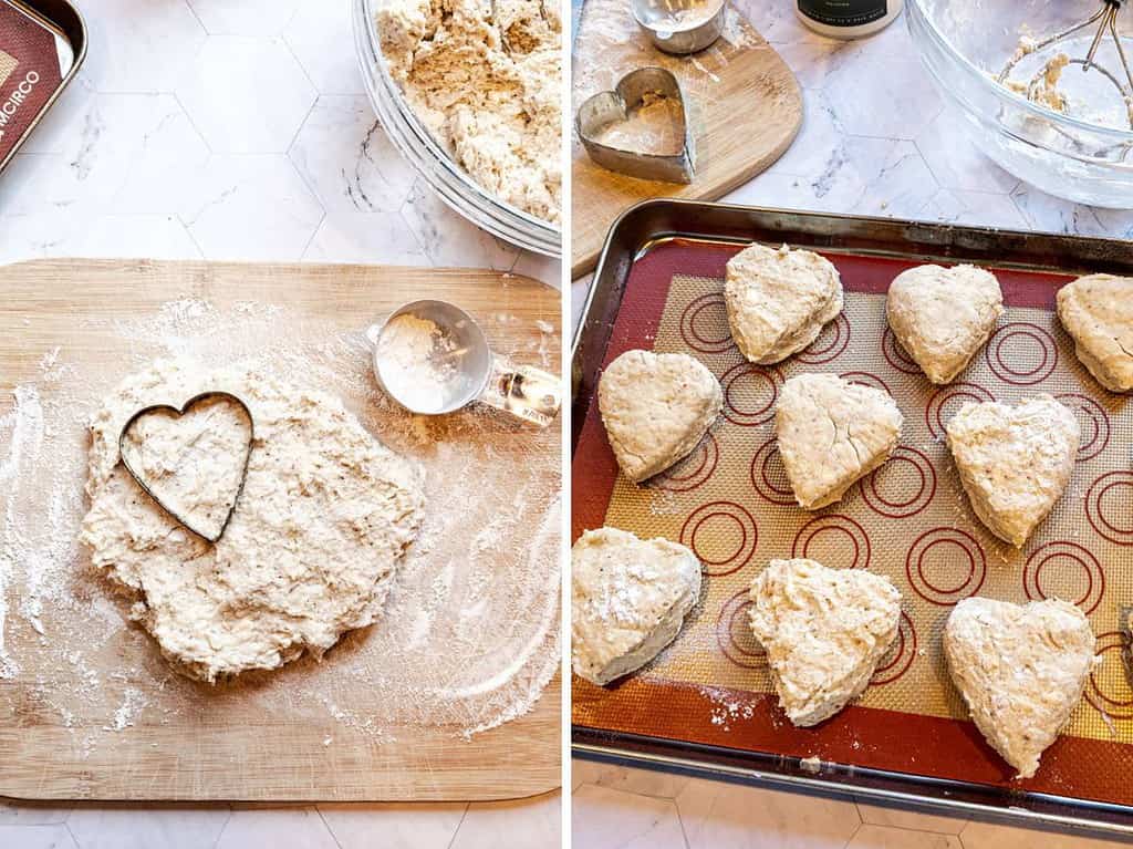 dough on a cutting board using a heart shaped cookie cutter to make scones