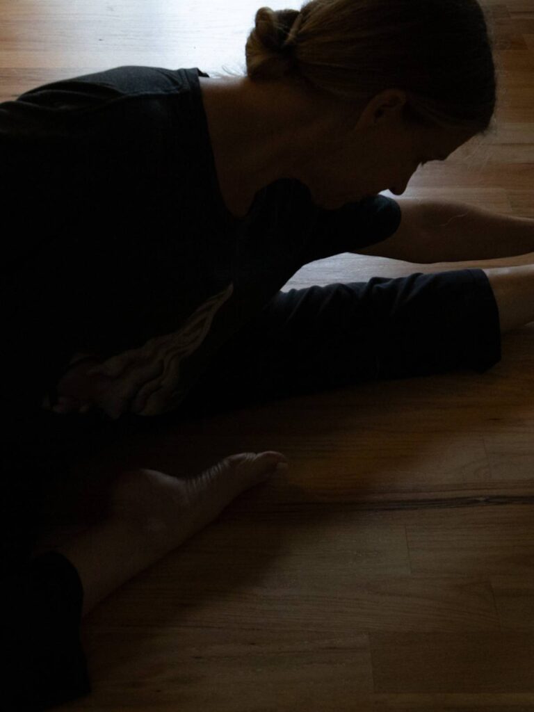 woman stretching to prevent back injury