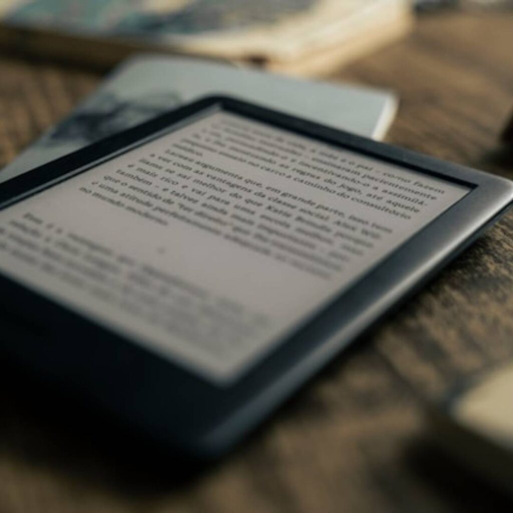 open kindle on a wood desk