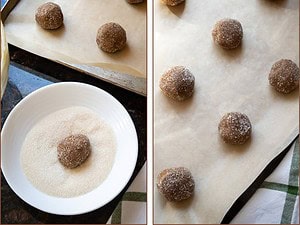 cookie dough being rolled in sugar and placed on a lined baking sheet