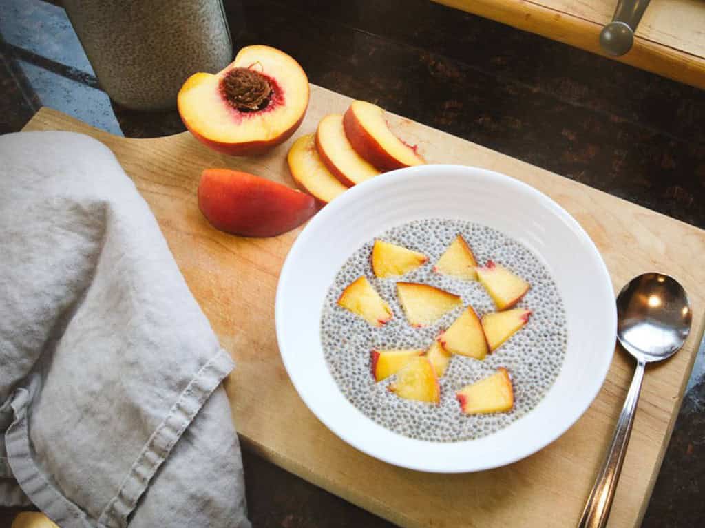 bowl of chia seed pudding with sliced peaches