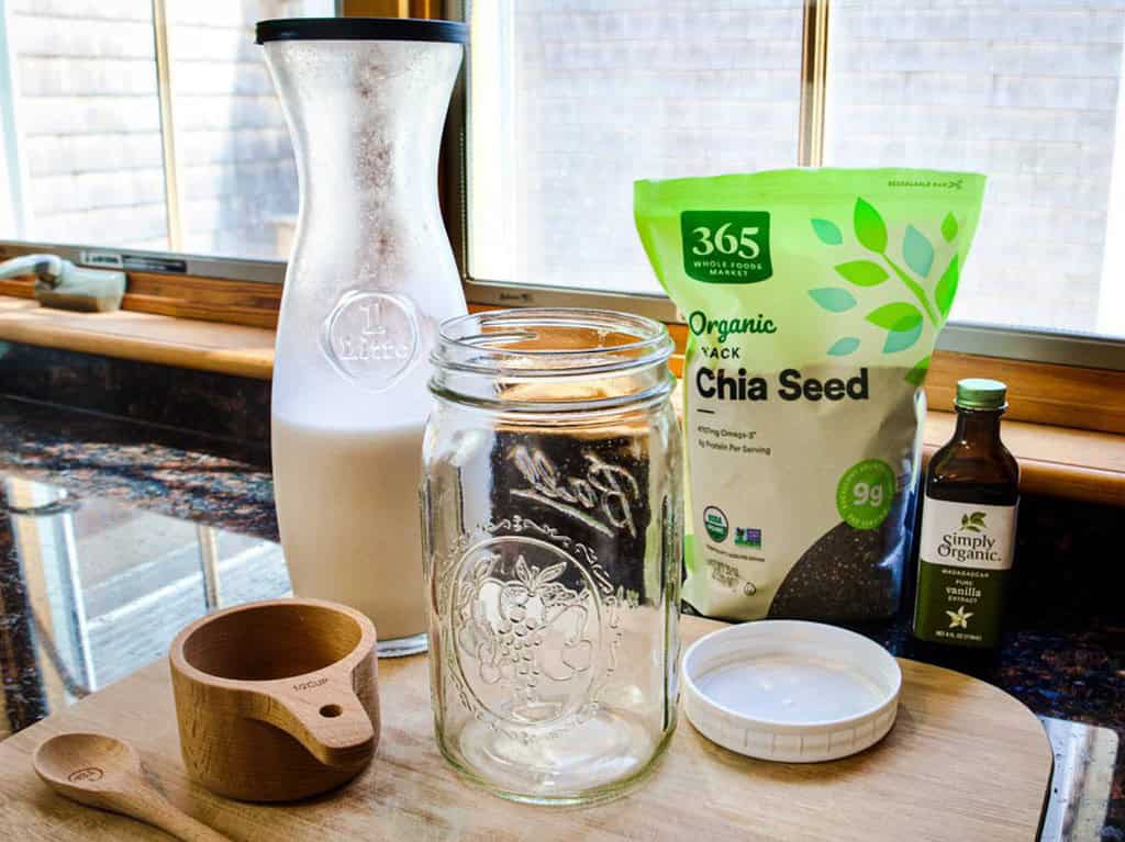 chia seed pudding ingredients bag of chia seeds vanilla plant based milk mason jar and measuring cup and spoon