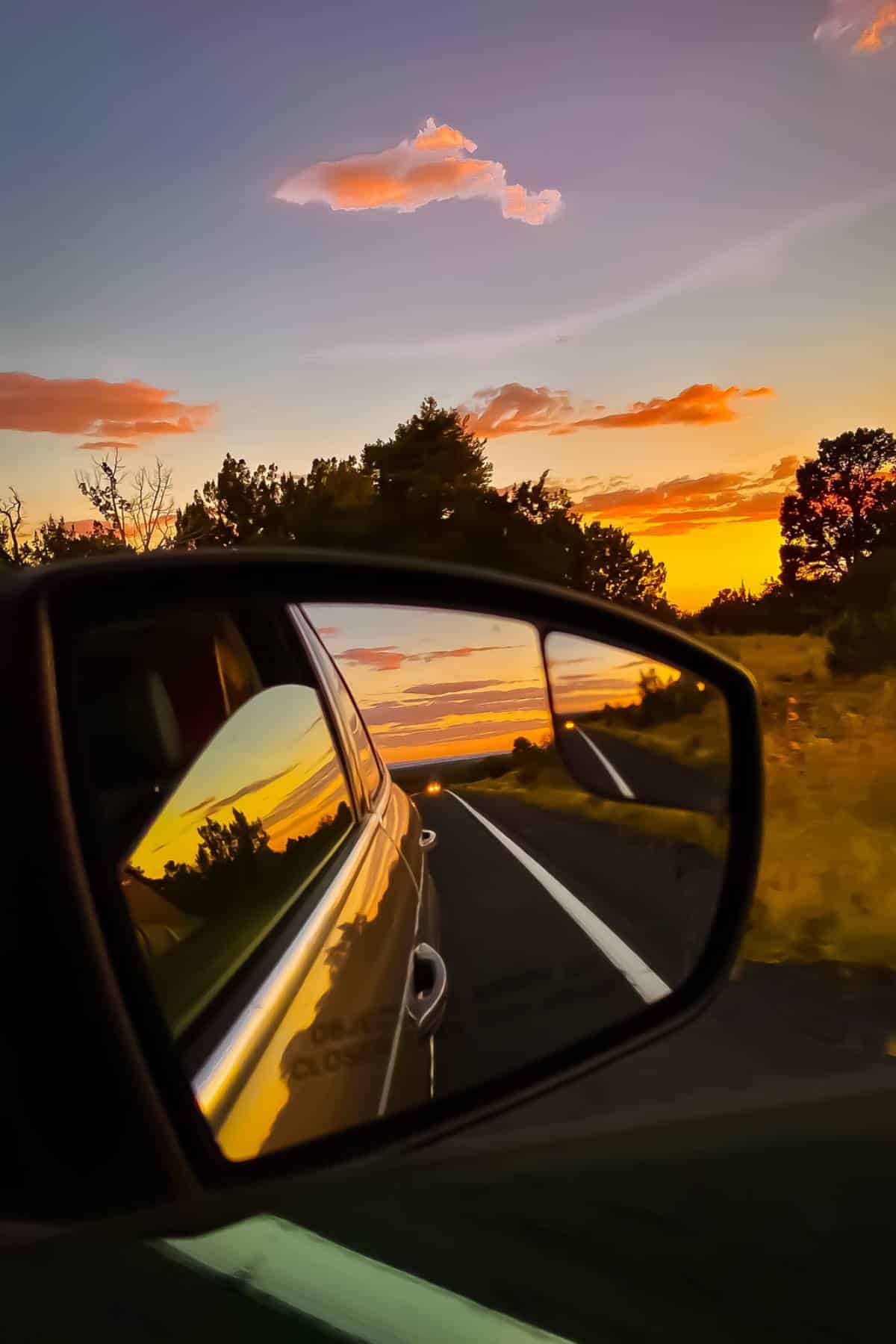 side door mirror as the sun is setting