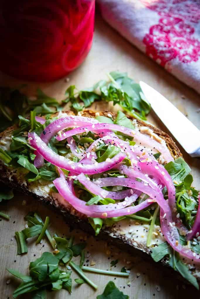 open-faced-hummus-sandwich-with-arugula-pickled-red-onions