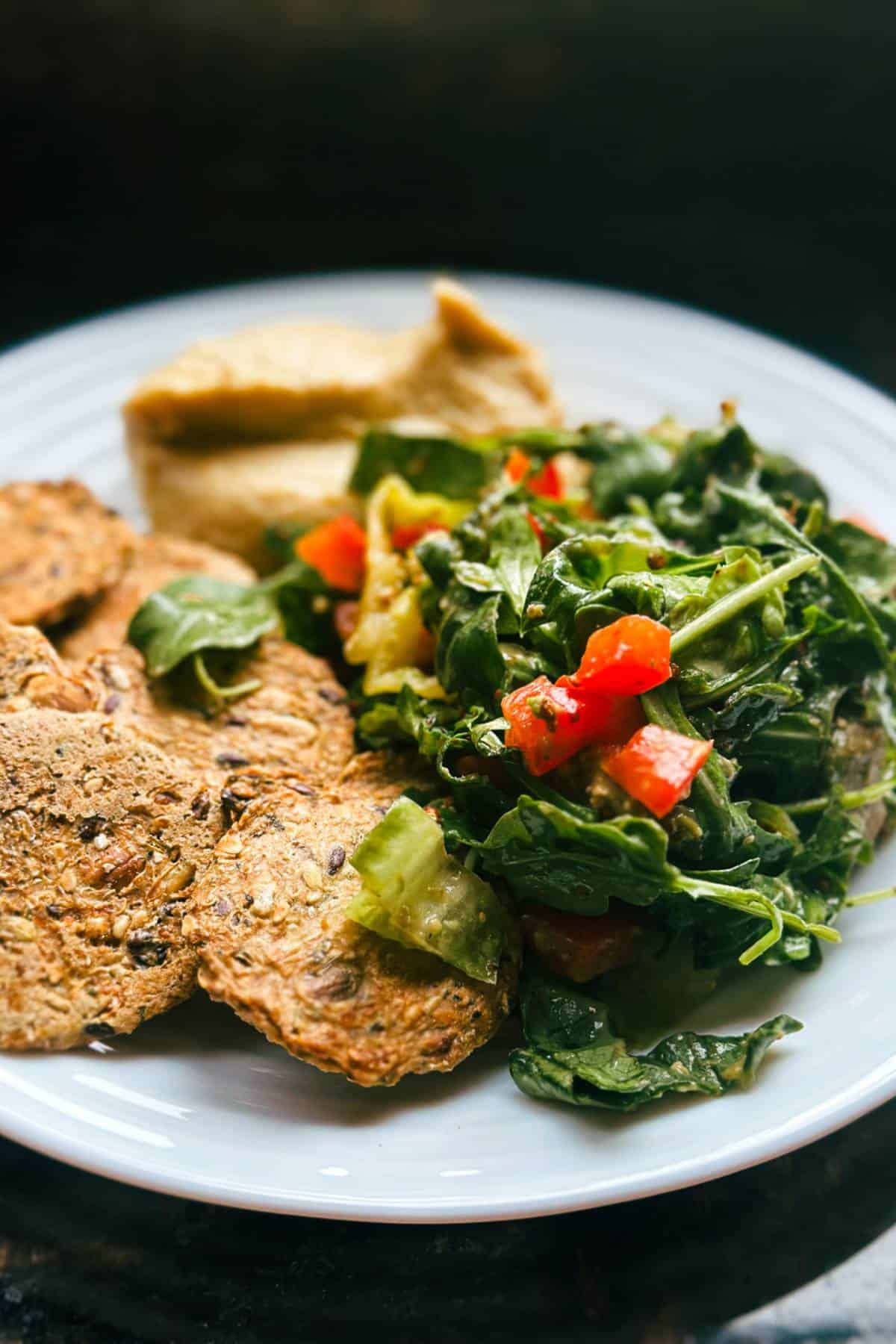 plate-with-seed-crackers-greens-hummus