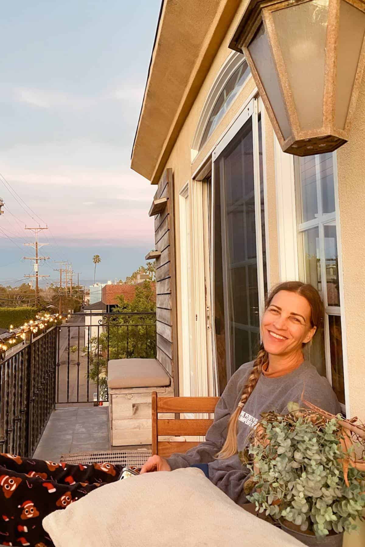 woman-smiling-sitting-on-balcony