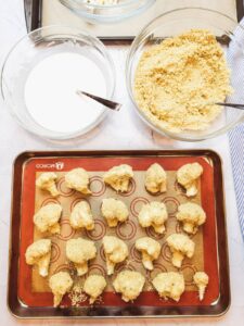 vegan-buffalo-cauliflower-wings-on-a-silicone-lined-baking-sheet