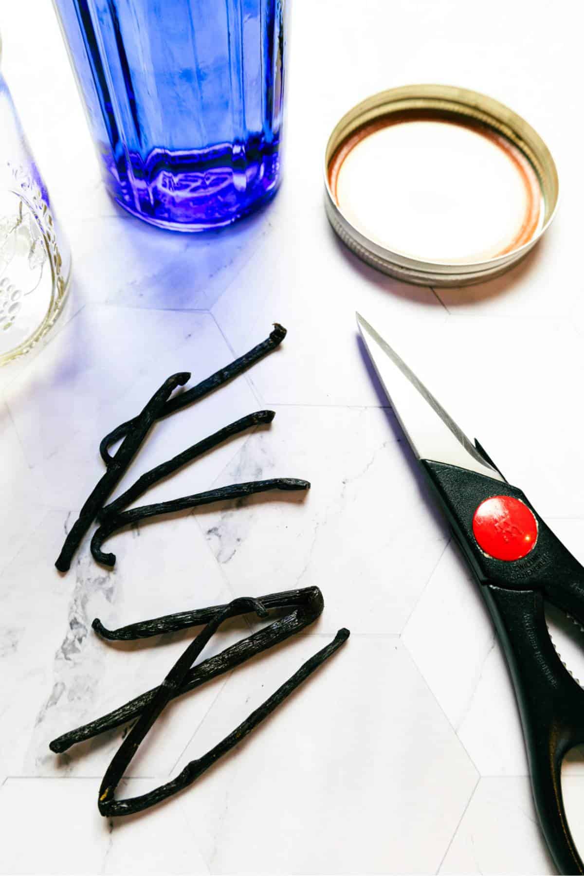 vanilla-beans-for-vanilla-extract-scissors-glass-blue-jar