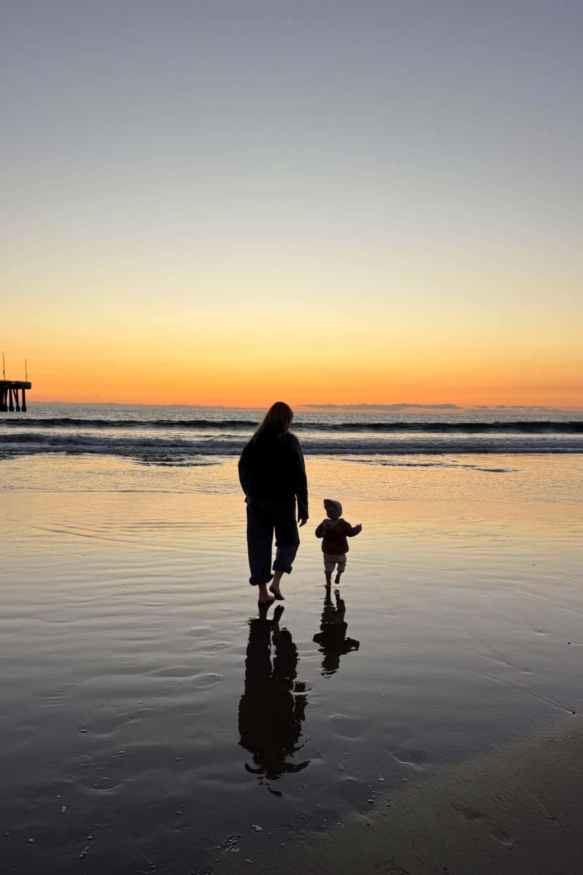 mother child on beach at sunset